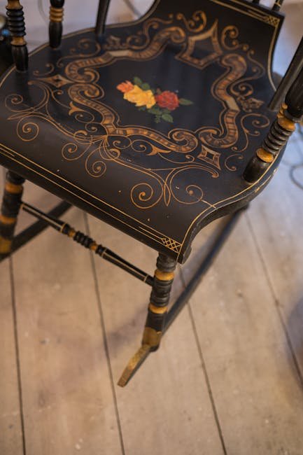 vintage rocking chair with floral patterns on a wooden seat.