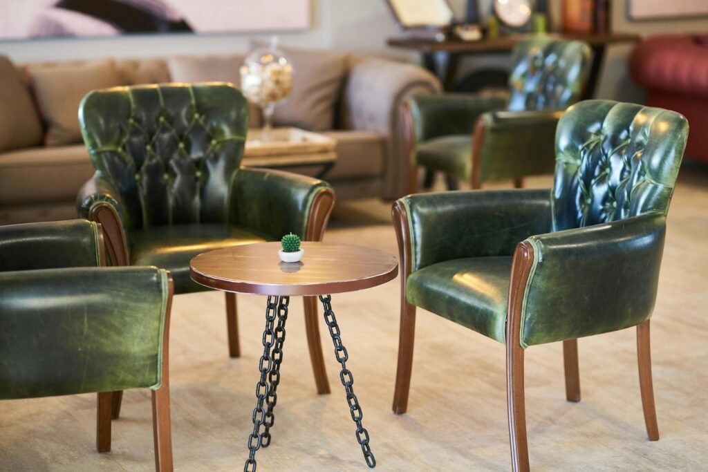 Stylish green leather armchairs with a chic table in a contemporary room.