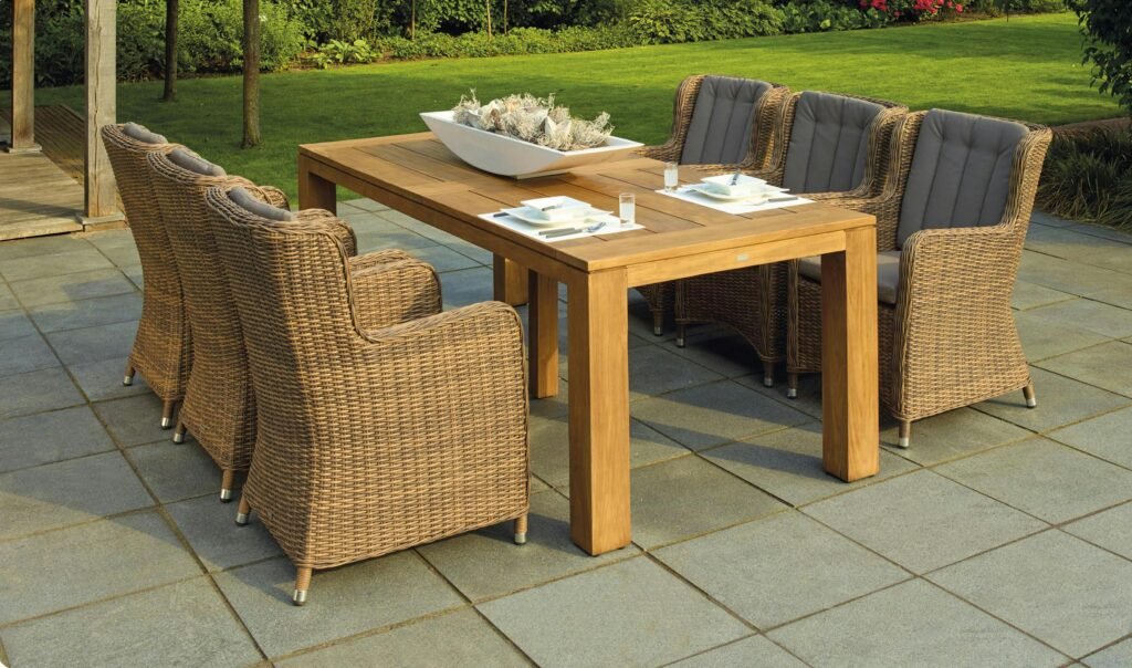outdoor patio with rattan chairs and a wooden table, perfect for relaxation.