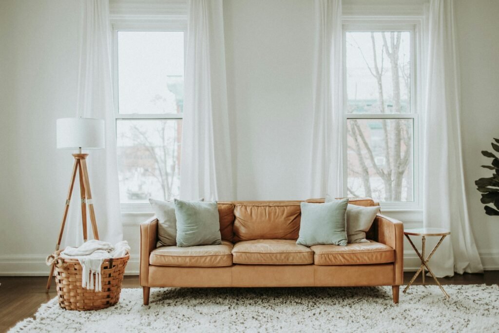 A cozy minimalist living room with a leather sofa and stylish decor.