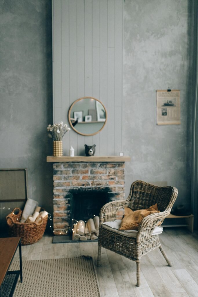 Charming interior of a rustic living room featuring a wicker chair after repairs, brick fireplace, and wooden decor.