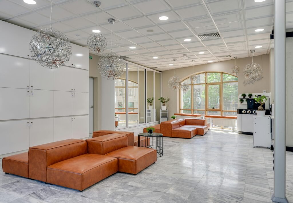 Spacious modern lounge featuring leather sofas and contemporary lighting